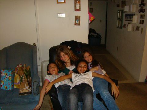 1989 Ford Bronco - Four girls are gathered together on a couch, with gifts nearby, suggesting a holiday or celebration.