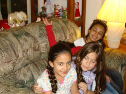 1989 Ford Bronco - Three girls smile for the camera while sitting on a couch adorned with holiday decorations.