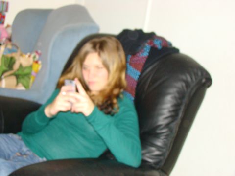 1989 Ford Bronco - Woman using a cell phone while sitting in a chair.