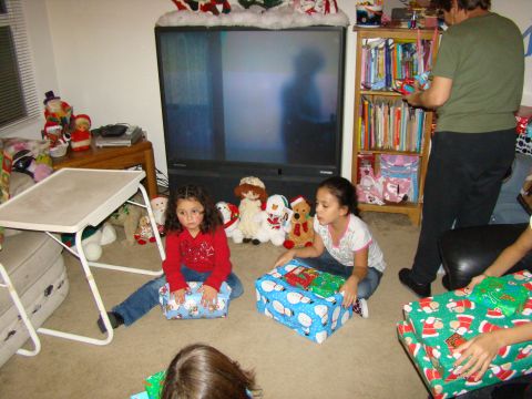 1989 Ford Bronco - Children anticipate opening gifts on Christmas morning, surrounded by holiday decorations.