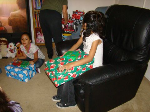 1989 Ford Bronco - Children sit with Christmas gifts in a living room, anticipating the holiday.