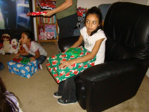 1989 Ford Bronco - Children sit on the floor and in a chair, surrounded by Christmas presents.