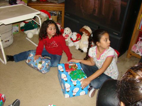1989 Ford Bronco - Children sit on the carpet surrounded by stuffed animals and Christmas gifts.