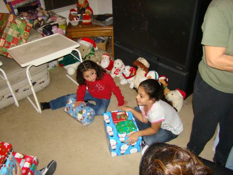 1989 Ford Bronco - Two young girls sit on the floor with Christmas presents and stuffed animals around them.