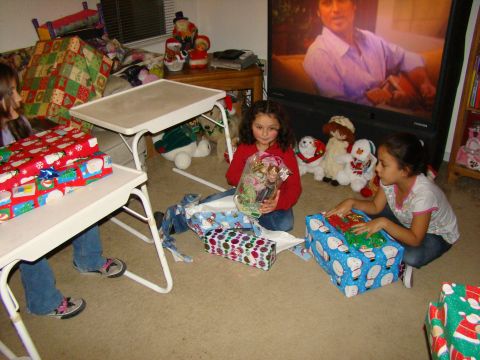 1989 Ford Bronco - Children excitedly open Christmas gifts in a living room, with holiday decorations visible.