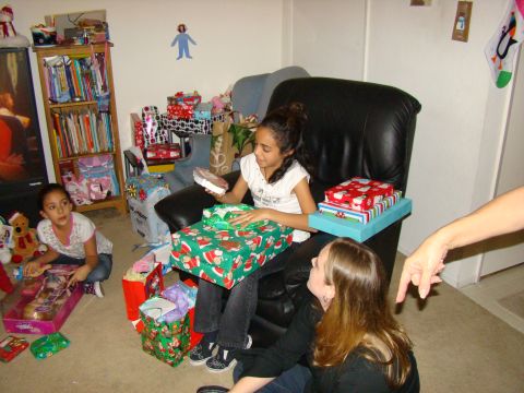 1989 Ford Bronco - A family gathers to open presents on Christmas morning, with many gifts piled around.