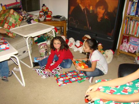 1989 Ford Bronco - Two young girls unwrap gifts on Christmas morning surrounded by stuffed animals and holiday decorations.