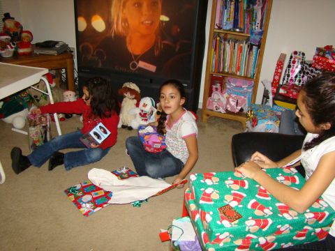 1989 Ford Bronco - Children excitedly open gifts on Christmas morning, with a television playing in the background.