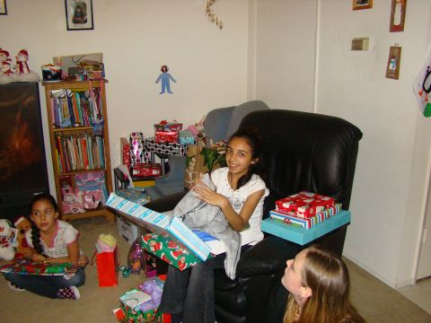 1989 Ford Bronco - Children excitedly open presents on Christmas morning, surrounded by holiday decorations.