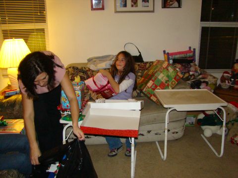 1989 Ford Bronco - A holiday gathering with gifts being opened in a cozy living room setting.