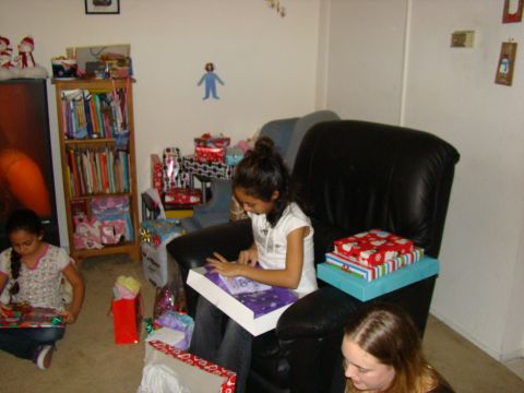 1989 Ford Bronco - Children excitedly open gifts in a room decorated for a holiday.