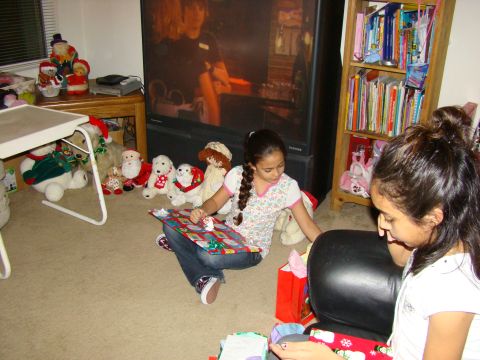 1989 Ford Bronco - Children opening gifts on the floor in a living room, with stuffed toys and a TV in the background.