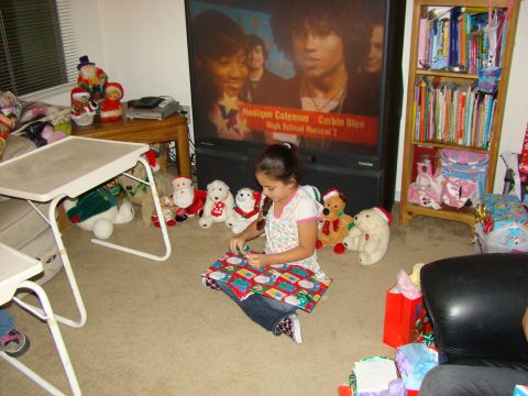 1989 Ford Bronco - A young girl unwraps a present during the holidays, with a movie playing on the television.