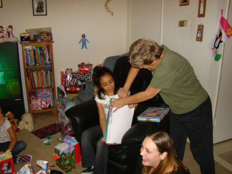 1989 Ford Bronco - A holiday gathering with gifts being opened in a living room.
