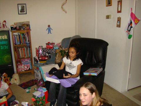 1989 Ford Bronco - A holiday gathering with girls opening presents in a living room.