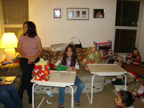 1989 Ford Bronco - A family celebrates Christmas together, opening gifts in a living room setting.