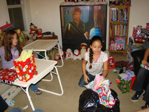 1989 Ford Bronco - A festive holiday scene unfolds as children gather to open presents in a room adorned with Christmas decorations.