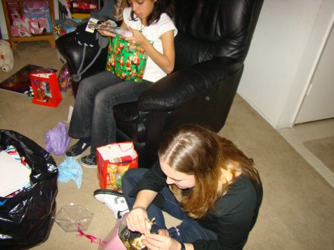 1989 Ford Bronco - Two young girls are engaged in opening presents, surrounded by gift bags and wrapping paper.