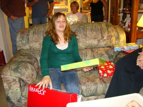 1989 Ford Bronco - A group of people are gathered around a sofa, some opening gifts during a holiday celebration.