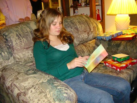 1989 Ford Bronco - Woman reads a card while sitting on a couch surrounded by Christmas gifts.