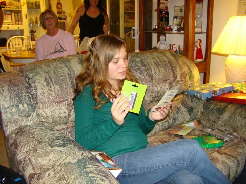 1989 Ford Bronco - A woman sits on a patterned couch, examining a gift while others are in the background.