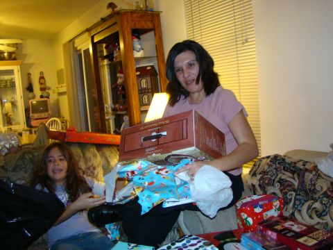 1989 Ford Bronco - A woman and a young girl are surrounded by Christmas gifts, unwrapping presents.
