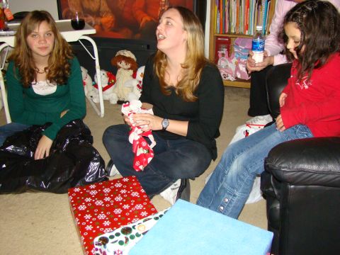 1989 Ford Bronco - A group of people are gathered around, opening gifts during a holiday celebration.