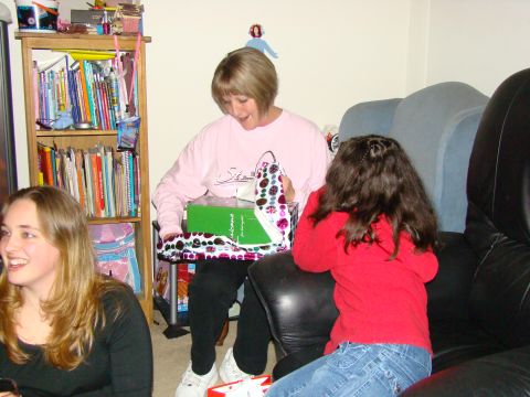 1989 Ford Bronco - A family celebrates a holiday by opening presents in a living room setting.