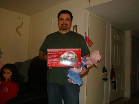 1989 Ford Bronco - A man holds a boxed CD player while a young girl watches from a couch.