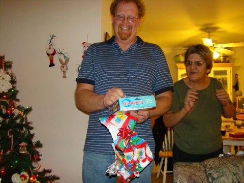 1989 Ford Bronco - A man and woman are opening presents during a Christmas celebration.