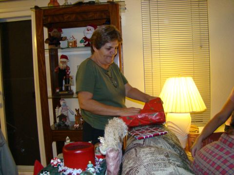1989 Ford Bronco - A woman is busy wrapping a Christmas present in a living room setting.