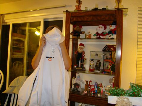 1989 Ford Bronco - A person holds up a white hoodie with the Chicago Bears logo in front of a display cabinet.