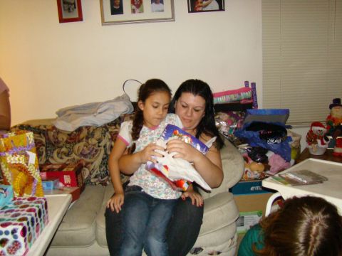1989 Ford Bronco - A mother and daughter unwrap presents during a holiday celebration.