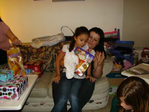 1989 Ford Bronco - A woman and child are sitting on a couch with gifts around them.