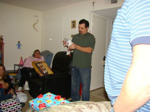 1989 Ford Bronco - A holiday gathering with people opening presents in a living room.