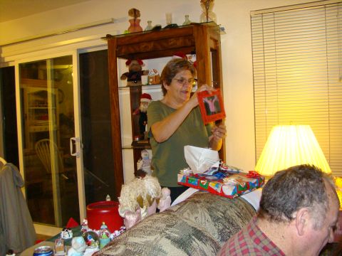 1989 Ford Bronco - A woman holds up a framed picture while opening gifts during a holiday celebration.