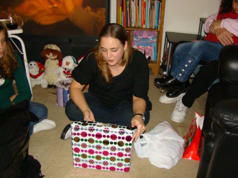 1989 Ford Bronco - A group of people are gathered on the floor, opening presents during a holiday celebration.