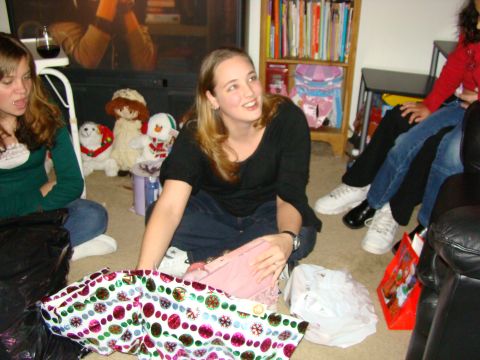1989 Ford Bronco - A group of people are gathered on the floor, opening gifts during a holiday celebration.