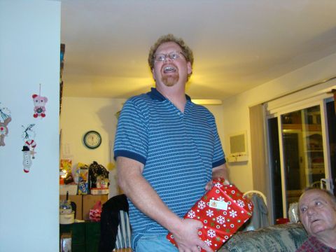 1989 Ford Bronco - A man excitedly holds a Christmas gift while another man watches.