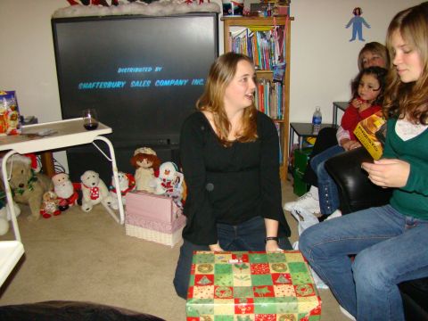 1989 Ford Bronco - A group of people are in a room with a TV and presents, likely during a holiday gathering.