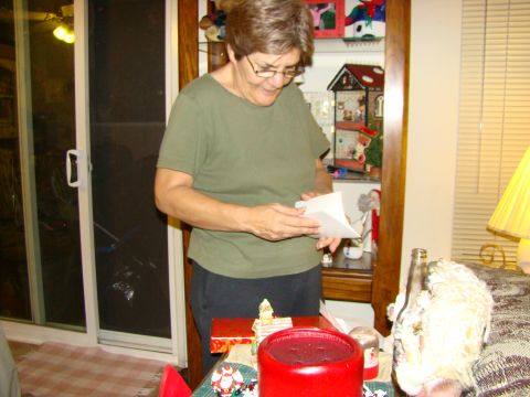 1989 Ford Bronco - A woman opens a letter indoors, with gifts and decorations visible on a table.