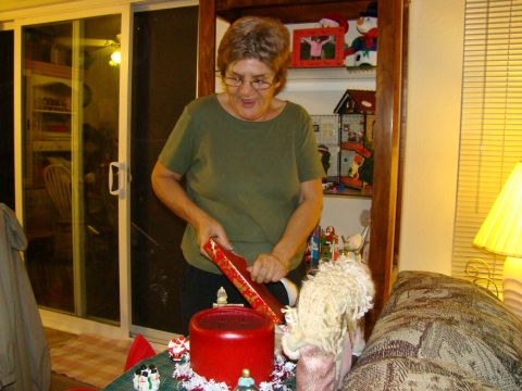 1989 Ford Bronco - A woman unwraps a gift in a room decorated for Christmas.