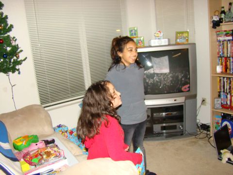 1989 Ford Bronco - Two girls watch television in a room with a Christmas tree and presents.