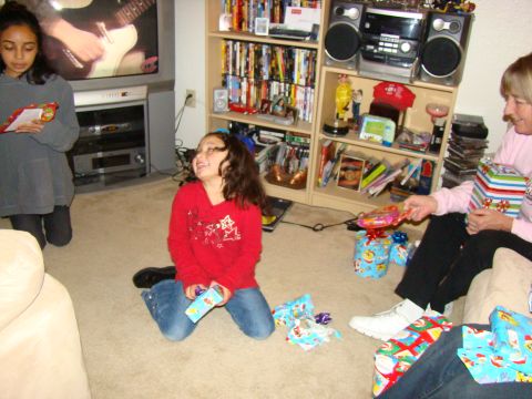 1989 Ford Bronco - Children and an adult open Christmas presents in a living room.