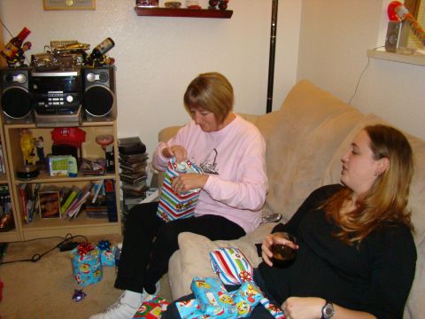 1989 Ford Bronco - Two women are opening presents on a couch during a holiday gathering.