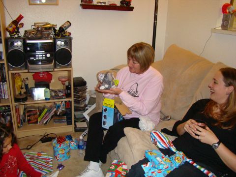 1989 Ford Bronco - A woman receives a stuffed elephant as a gift while sitting on a couch surrounded by presents.