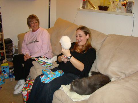 1989 Ford Bronco - Two women and a cat are on a couch, surrounded by gifts.