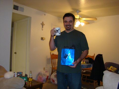 1989 Ford Bronco - Man holding a mug and a gift bag inside a room.