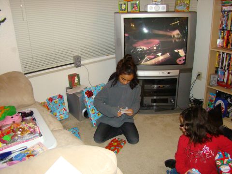 1989 Ford Bronco - Kids are opening Christmas gifts in front of a television set.