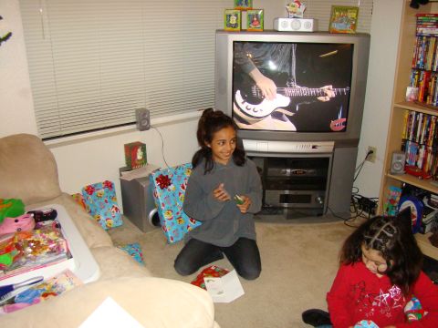 1989 Ford Bronco - A holiday gathering in a living room, with gifts and entertainment provided by a television.